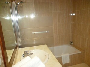 A bathroom with a sink, mirror, and shower. - Roque Del Conde (Costa Adeje)