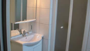 Shower, hair dryer, soap, toilet paper