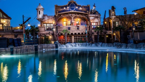 A large building with a pirate-themed facade, including a sign that reads "Captain Pirate."