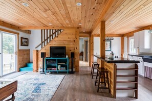 Step up to the upper level via the central staircase and enjoy the cozy living area with a flat-screen TV and comfortable seating.