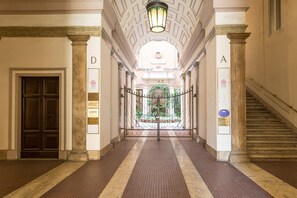 A hallway with a double door, a staircase, and a decorative ceiling. - Lovely New home, via Nazionale . (Roma)