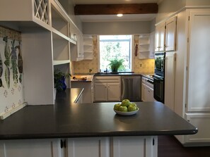 Enjoy cooking in this well-equipped kitchen with a central island and stainless steel appliances.