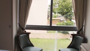 A room with a large window, two chairs, a bed, and a rug. - ELEGANT 1BED APARTMENT 50 METRES FROM PLAYA DE LOS INGLESES (Punta del Este)