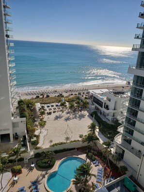 A resort with a pool, beach, and ocean view.