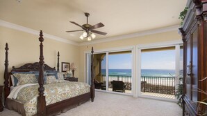 A bedroom with a four-poster bed, a ceiling fan, and a balcony with a view of the beach. - Gulf Front Luxury - Private Elevator/5 Master bdrms - each w/private bath  (Navarre)