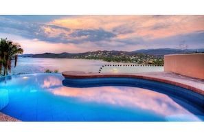 Enjoy a refreshing swim with a clear view of the sea and distant hills.