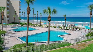 A resort with multiple swimming pools, palm trees, and a beach view. - BREATHTAKING OCEAN VIEWS & UPDATED CONDO  (New Smyrna Beach)