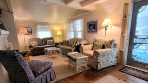 A cozy living room with wooden floors, a fireplace, and a large window overlooking a dock. - Mount Gretna Memories! 10 minutes to Renaissance Faire (Mt Gretna)