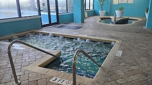 An indoor swimming pool with a 3 FT depth marker, a hot tub, and a tiled floor. - Beautiful oceanview 1 bedroom with king bed, full kitchen, and water amenities  (Myrtle Beach)