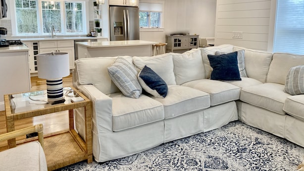A modern living room with a sectional sofa, a coffee table, and a patterned rug. - Newly Renovated Near Amazing Sunset Beach (Falmouth)