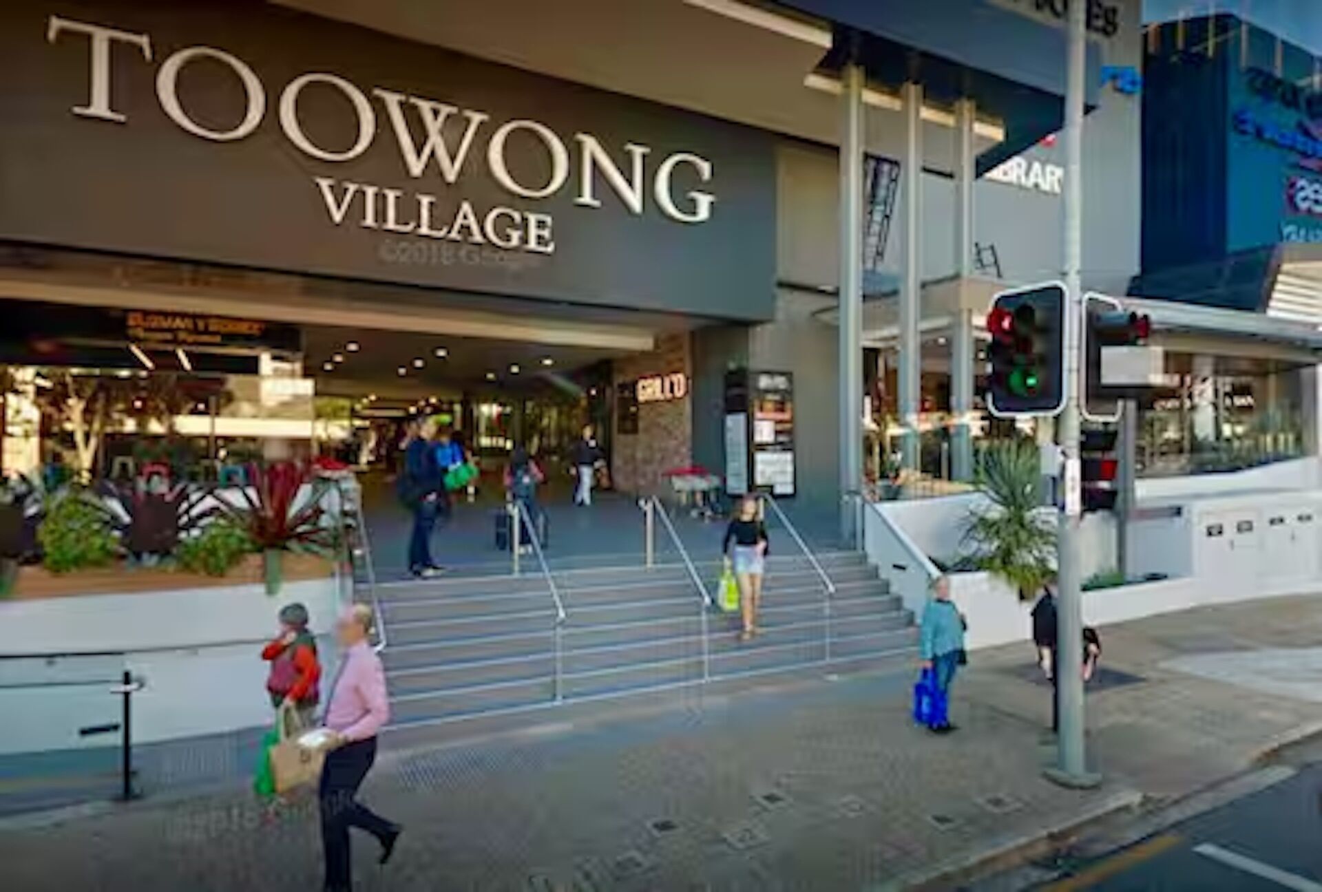 A shopping area with a prominent 'TOOWONG VILLAGE' sign.