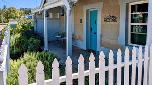 A two-story building with a blue door and a 'WELCOME' sign. - Refurbished miners cottage 5 min from Moonta Bay + free internet (Moonta)