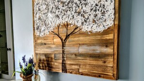 A fireplace with a white mantel and a painting of a tree with flowers. - Refurbished miners cottage 5 min from Moonta Bay + free internet (Moonta)