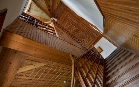 A wooden interior with a staircase leading to an upper level.