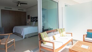 A modern hotel room with a bed, a wooden sofa, and a wooden table. - Spectacular Beach front 2 Bedroom Condo (Riviera Nayarit)