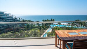A balcony with a view of the ocean and a pool area. - Spectacular Beach front 2 Bedroom Condo (Riviera Nayarit)