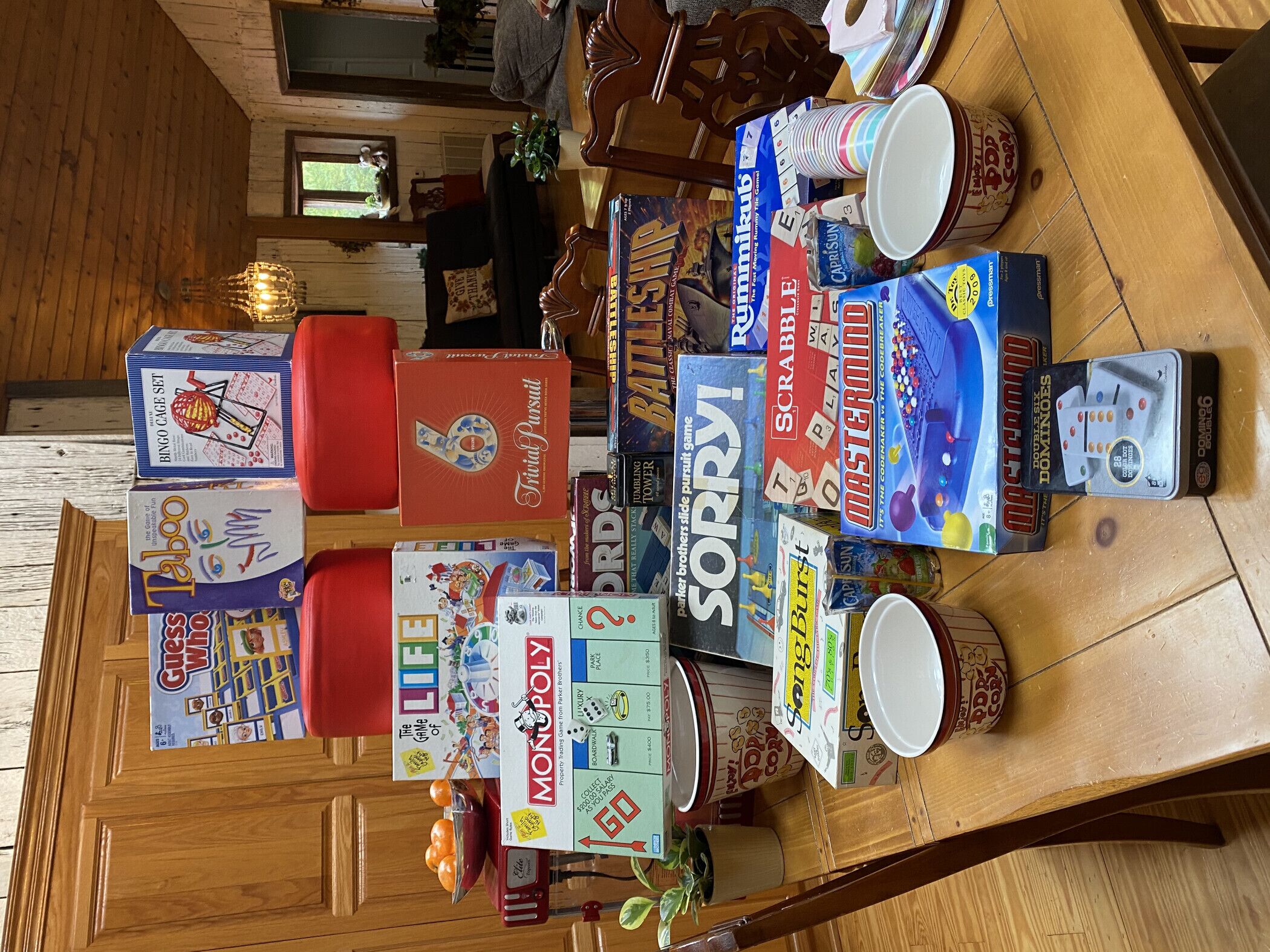 A table with various board games and a few cups.
