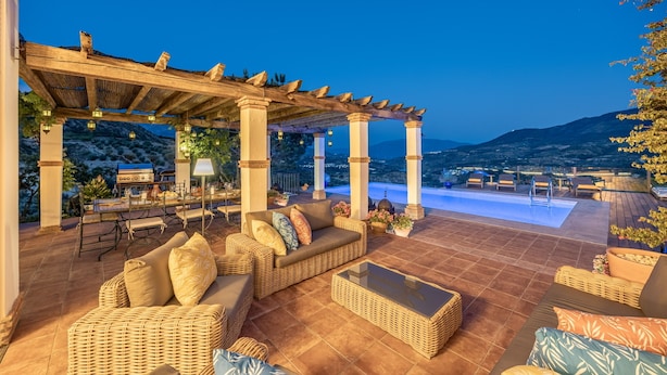 An outdoor patio with wicker furniture, a pool, and a pergola. - Exclusive Country Villa with Stunning Views & Infinity Pool (Restabal)