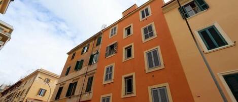 A row of multi-story buildings with uniform window designs and balconies.