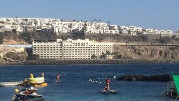 Guests can enjoy stunning ocean views from the cliffside building, with access to the sandy beach and a variety of recreational activities.