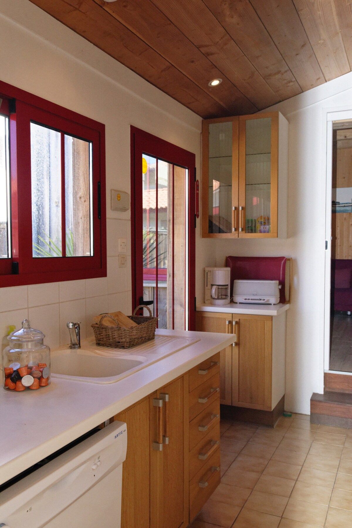 A kitchen with wooden cabinets, a microwave, and a coffee maker.