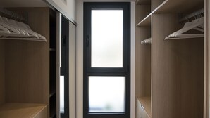 A walk-in closet with wooden shelving, a double door with frosted glass panels, and a ceiling vent. - Villa sea view in Pinarello - near Porto-Vecchio (ZONZA)