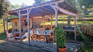 A wooden outdoor dining area with a covered patio, a grill, and a potted plant. - EXCEPTIONAL site: SPACIOUS VILLA 8 BEDS, SWIMMING POOL 15x5M, SAUNA (Le Val)