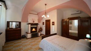 Un dormitorio con chimenea, muebles de madera y suelo a cuadros.