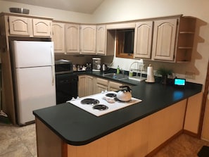 Enjoy cooking in this well-equipped kitchen with a central island, stovetop, and oven.