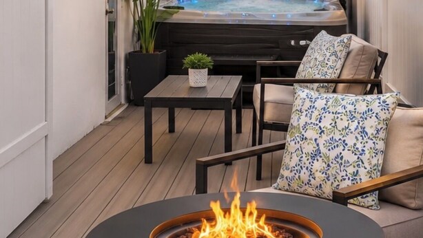 A patio with a fire pit, outdoor seating, a hot tub, and a view of palm trees. - 2BR Hot Tub Oasis - 2 Mi FLL, 4 Mi Beach, Sleeps 6 (Dania Beach)