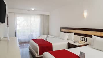A hotel room with two beds, a desk, a telephone, and a window with curtains.