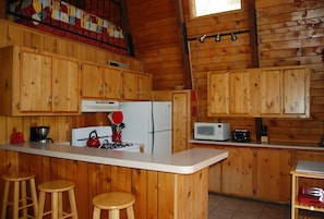 Kitchen with additional seating at bar for 3