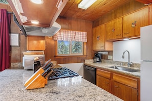 Kitchen equipped with a gas stove, coffee maker, and dishwasher.