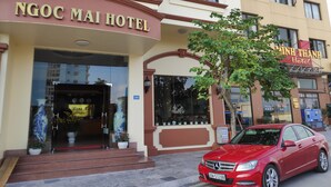 The exterior of Ngoc Mai Hotel with a red car parked in front. - Ngoc Mai Hotel (Bai Chay)