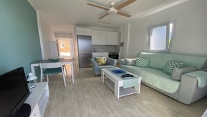 A compact living space with a kitchenette, a dining area, and a sofa. - Molino azul 1A (Valle Gran Rey)