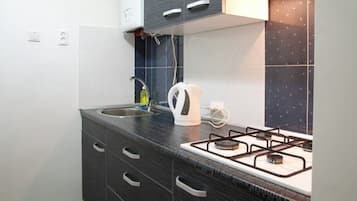 Apartment | Private kitchen | Fridge, stovetop, electric kettle, cookware/dishes/utensils