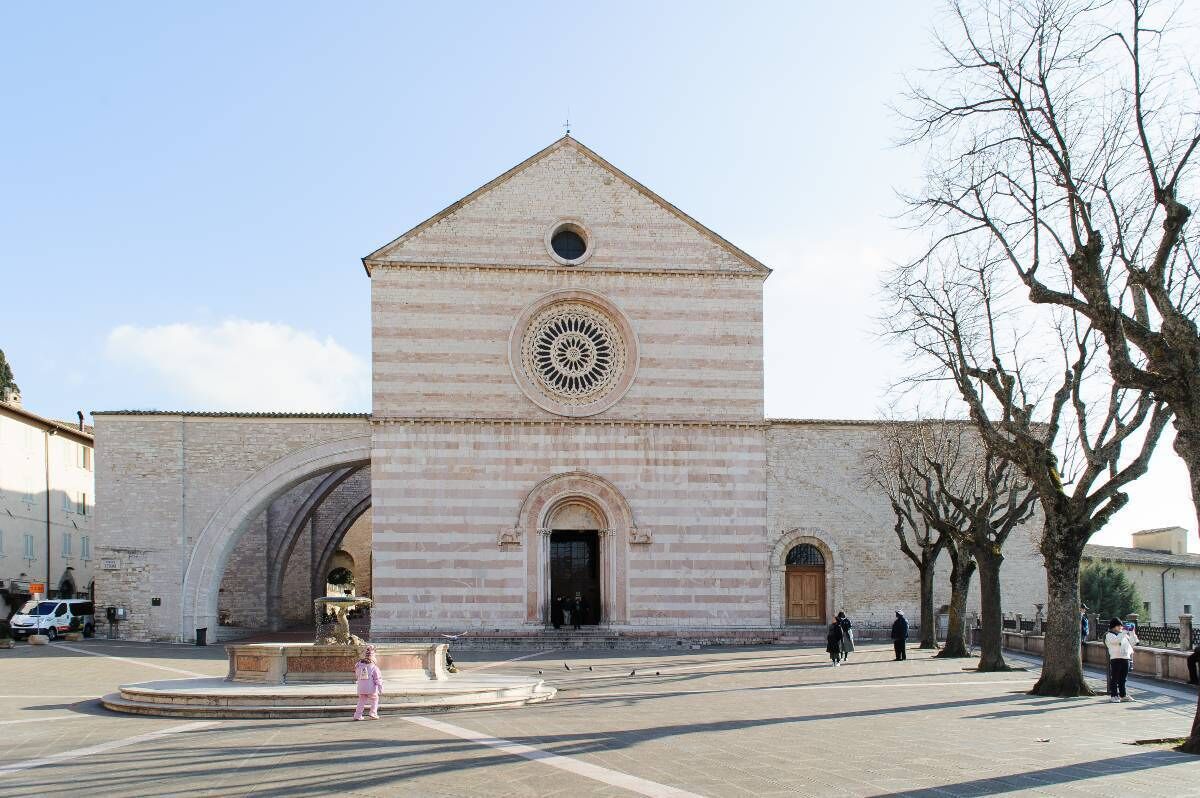 A historic building with a central circular window and a triangular roof.