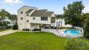 A two-story house with a pool and a deck. - It's All Good | 780 ft from the beach | Private Pool, Dog Friendly, Hot Tub (Virginia Beach)