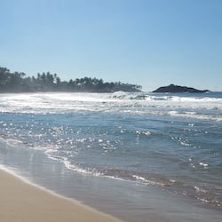 On the beach, surfing