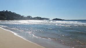 On the beach, surfing