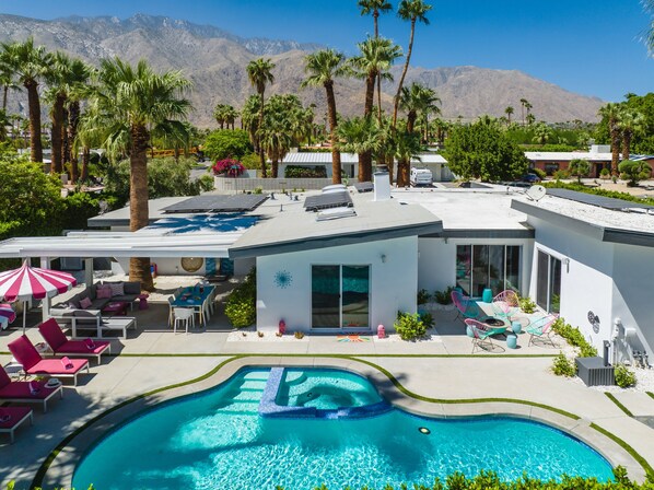 A modern pool area with a clear view of mountains in the background.