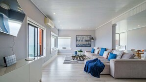 Un salón moderno con un sofá, una mesa de centro y un televisor.