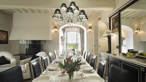 A dining room with a long table set for a meal, surrounded by chairs, and a chandelier above. - Luxury Villa located between Florence and Siena. A/C, swimming pool and SPA! (Tavarnelle val di Pesa)