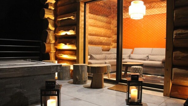 A cozy log cabin interior with a fireplace, wooden furniture, and a large window. - ----The evening Star---- (Saint-Martin-de-la-Porte)