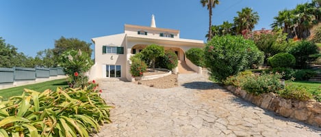A two-story building with a stone pathway leading to the entrance.
