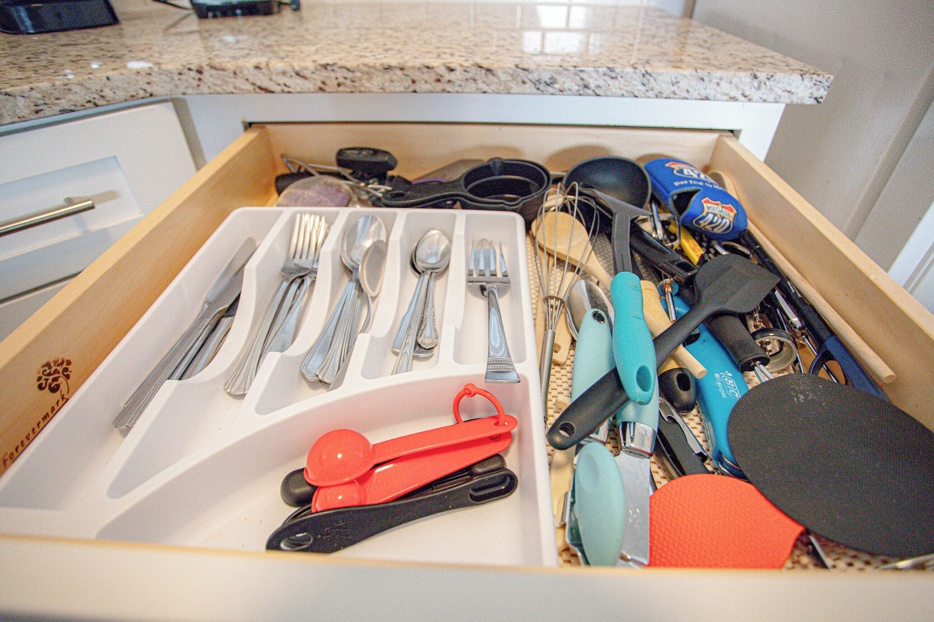 A drawer with utensils and kitchen tools.