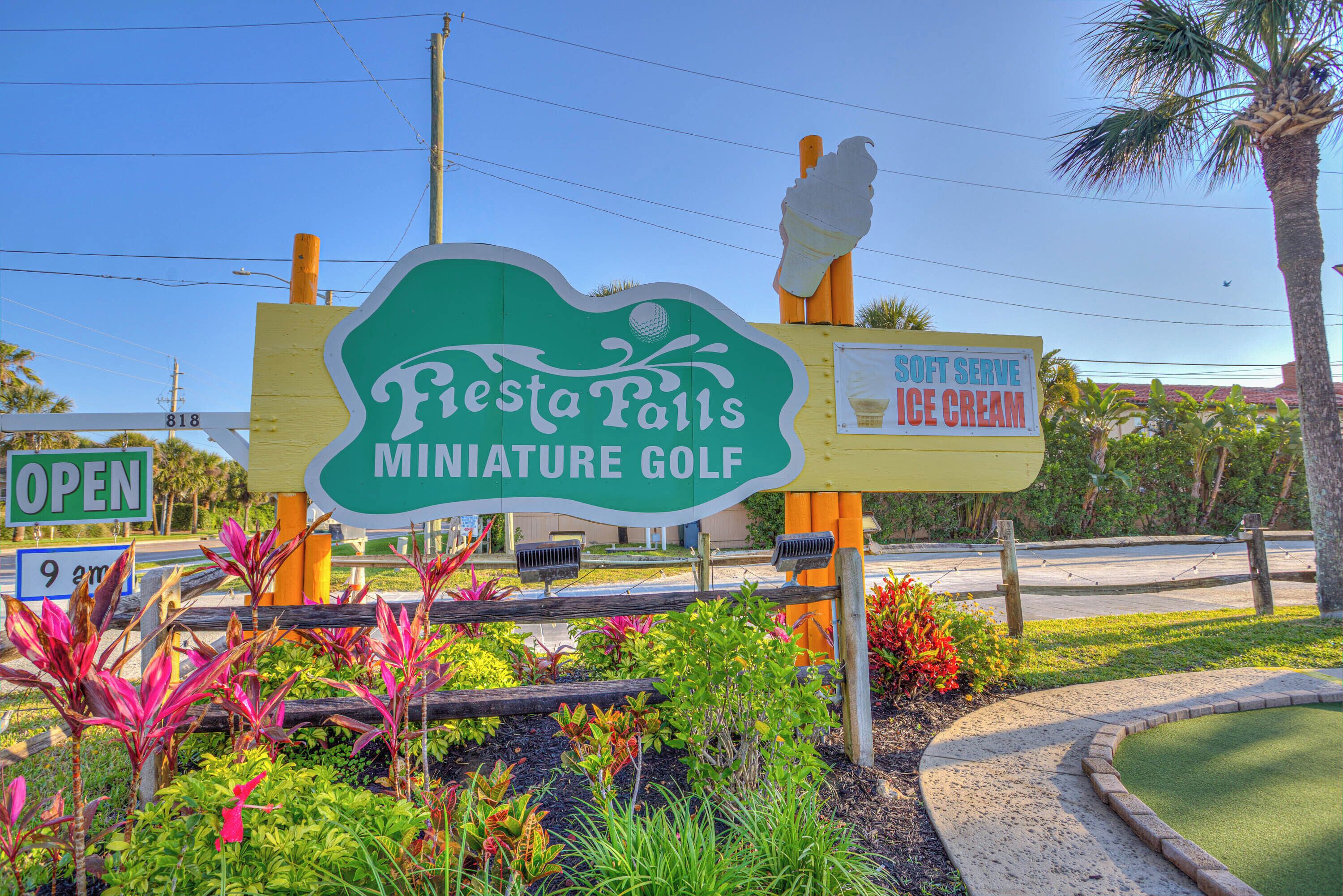 A sign for Fiesta Falls Miniature Golf with an ice cream advertisement.