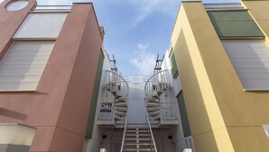 A narrow stairway flanked by buildings with external staircases and a clear sky above. - The Best Condo in Vera with a fantastic View (Vera)