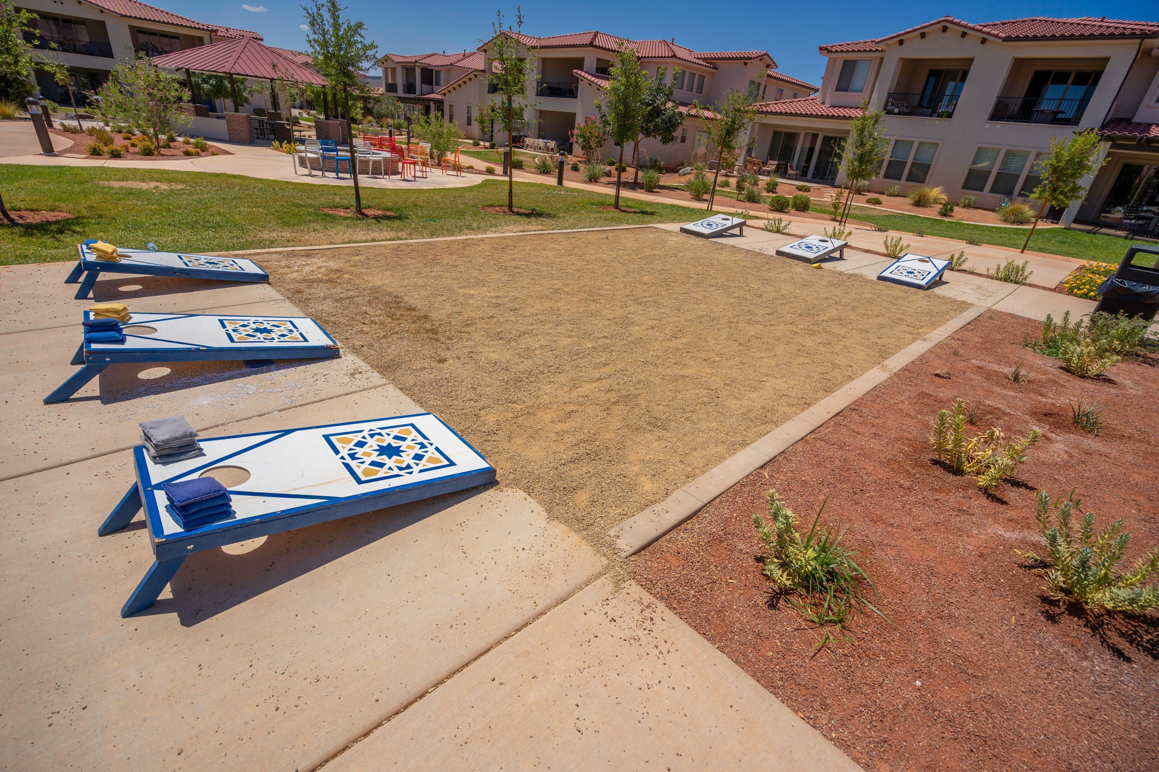 A courtyard with shuffleboard tables and outdoor seating.