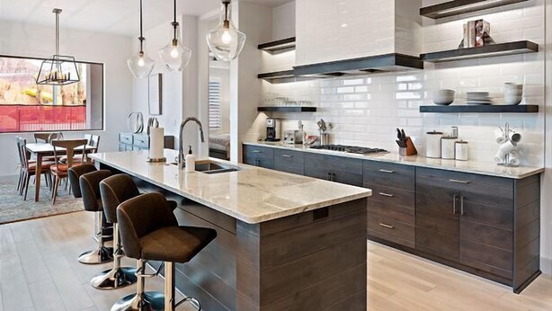 A modern kitchen with dark wood cabinets, a marble island, and pendant lighting. - Steps to Pool | 2 Family Rooms | Resort Pool Access | Arcadia #7 (Santa Clara)